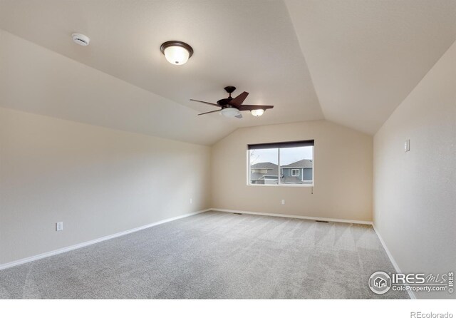bonus room featuring carpet flooring, lofted ceiling, a ceiling fan, and baseboards