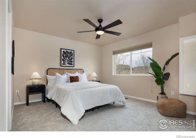 carpeted bedroom featuring baseboards and ceiling fan