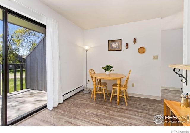 705 E Drake Rd Unit 22, Fort Collins, CO 80525 - dining room featuring a baseboard heating unit and wood finished floors
