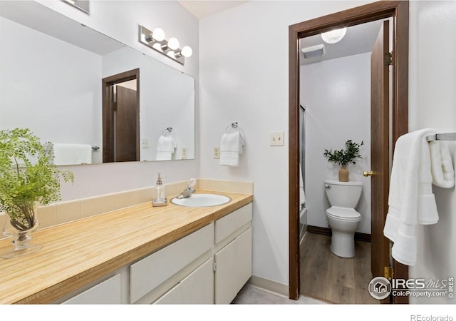 705 E Drake Rd Unit 22, Fort Collins, CO 80525 - full bathroom featuring vanity, toilet, wood finished floors, baseboards, and  shower combination