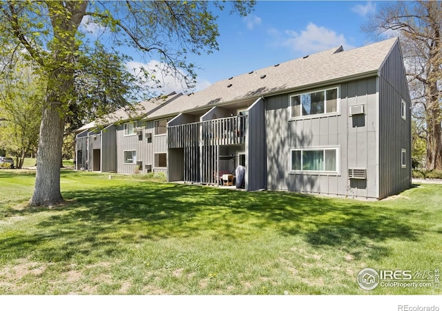 705 E Drake Rd Unit 22, Fort Collins, CO 80525 - rear view of property featuring a yard, a shingled roof, and board and batten siding