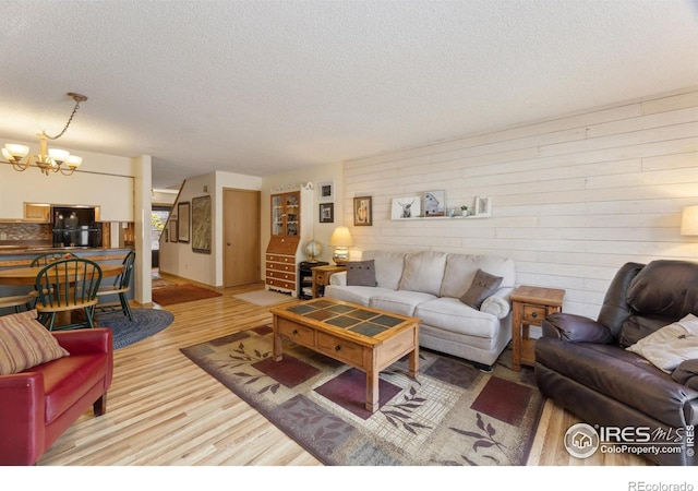 620 Macgregor Ave Unit 2, Estes Park, CO 80517 - living area featuring a chandelier, a textured ceiling, and light wood-style flooring
