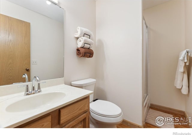 620 Macgregor Ave Unit 2, Estes Park, CO 80517 - bathroom with toilet, a shower, vanity, and wood finished floors