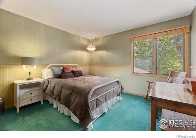 620 Macgregor Ave Unit 2, Estes Park, CO 80517 - carpeted bedroom with wallpapered walls and a wainscoted wall
