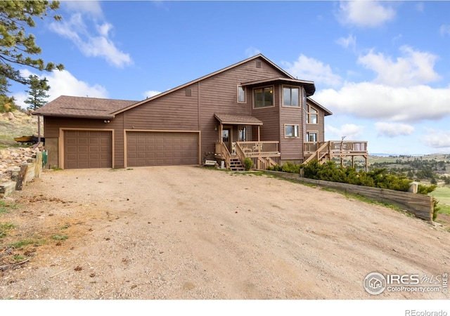 331 Laplata Dr, Livermore, CO 80536 - chalet / cabin featuring a garage, dirt driveway, and a deck