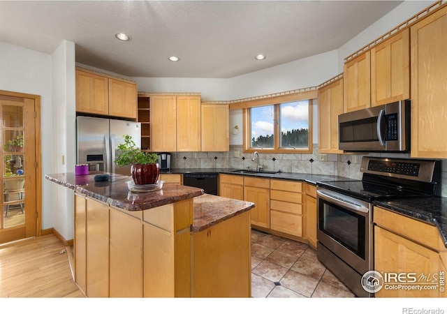 331 Laplata Dr, Livermore, CO 80536 - kitchen featuring stainless steel appliances, a sink, a center island, light brown cabinets, and recessed lighting