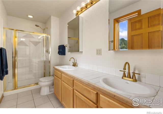 331 Laplata Dr, Livermore, CO 80536 - full bathroom featuring a stall shower, toilet, double vanity, and tile patterned floors