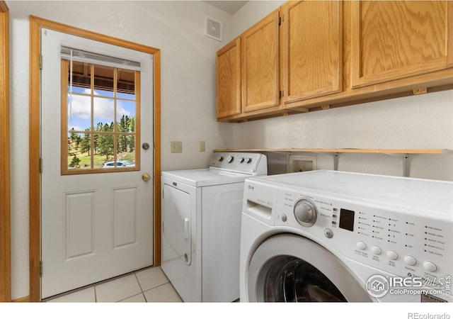 331 Laplata Dr, Livermore, CO 80536 - laundry room featuring washer and clothes dryer, cabinet space, and light tile patterned floors