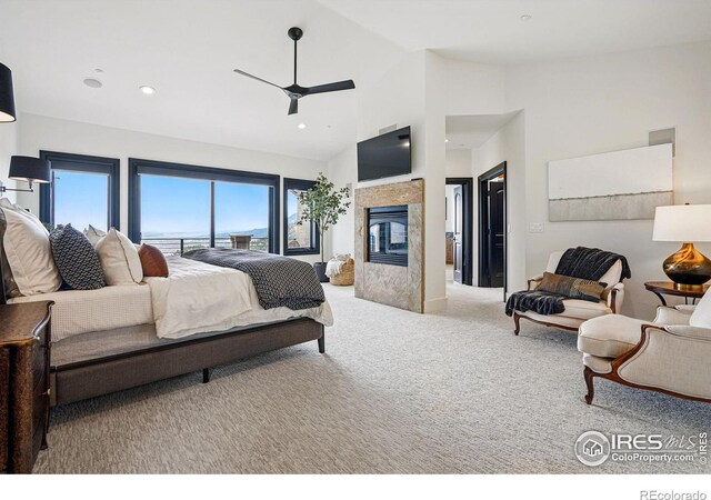 carpeted bedroom featuring recessed lighting, a multi sided fireplace, high vaulted ceiling, and a ceiling fan