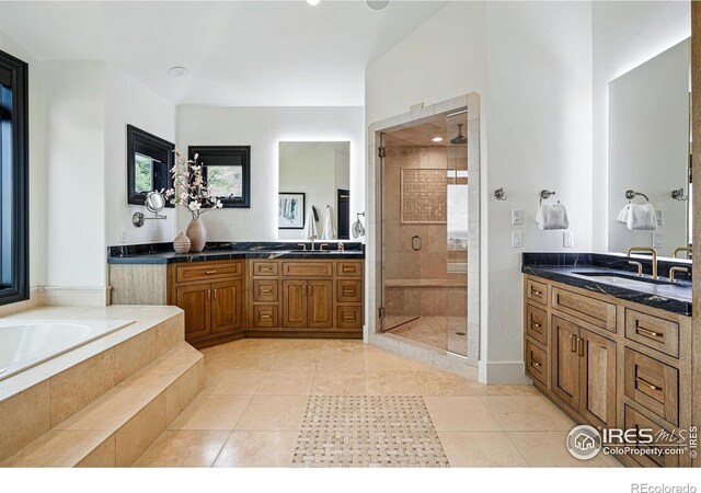 full bathroom featuring a stall shower, a bath, tile patterned flooring, two vanities, and recessed lighting