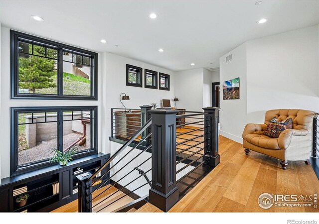 staircase with wood finished floors, recessed lighting, and baseboards