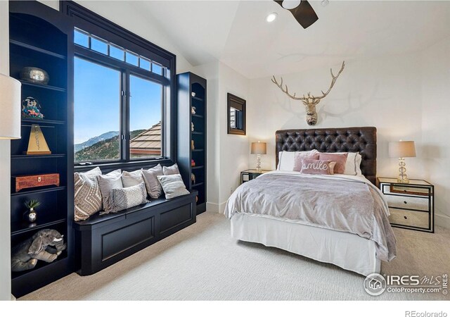 carpeted bedroom featuring baseboards, ceiling fan, and lofted ceiling