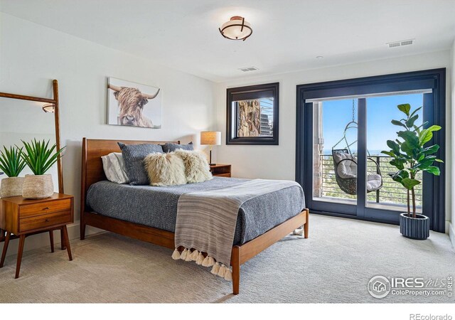 bedroom with light carpet and access to outside