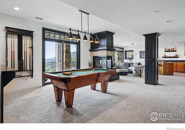 game room with carpet flooring, pool table, recessed lighting, a bar, and a multi sided fireplace