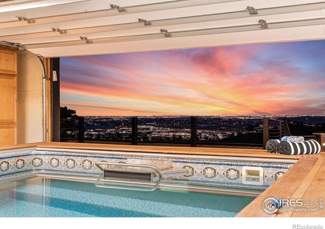 view of pool at dusk