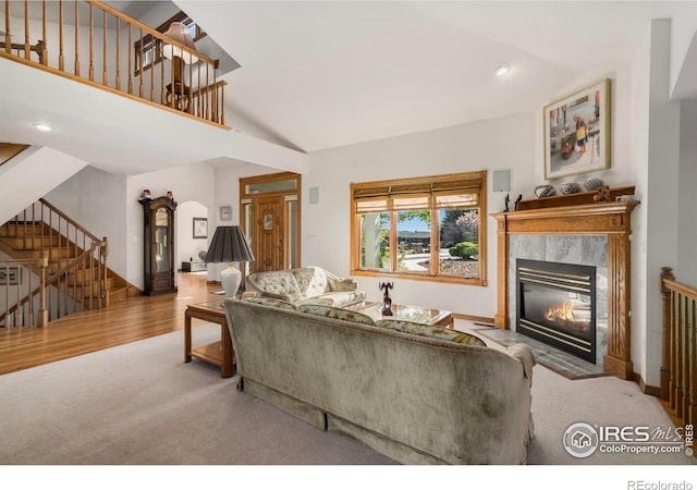 7309 Didrickson Ct, Fort Collins, CO 80528 - carpeted living room with stairs, a high end fireplace, arched walkways, baseboards, and recessed lighting