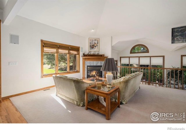 7309 Didrickson Ct, Fort Collins, CO 80528 - living room featuring lofted ceiling, a high end fireplace, wood finished floors, and baseboards