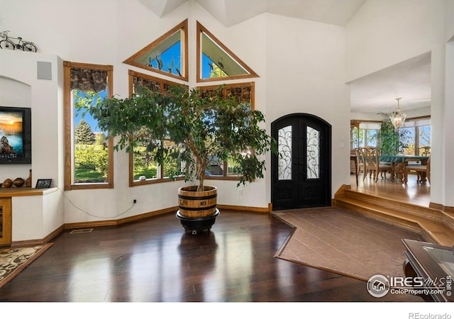 7309 Didrickson Ct, Fort Collins, CO 80528 - foyer featuring french doors, a towering ceiling, a chandelier, wood finished floors, and baseboards