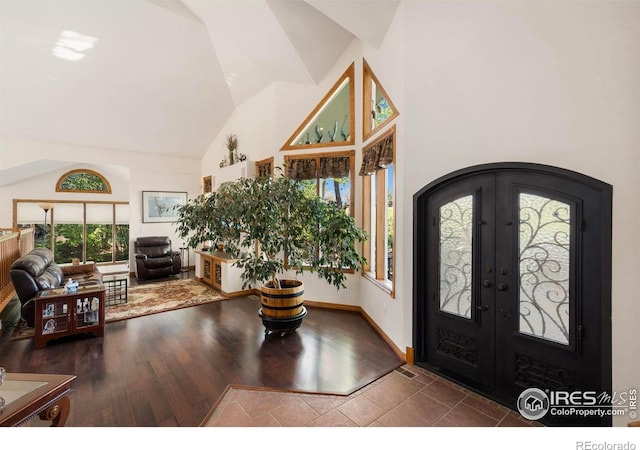 7309 Didrickson Ct, Fort Collins, CO 80528 - foyer with high vaulted ceiling, french doors, healthy amount of natural light, wood finished floors, and arched walkways