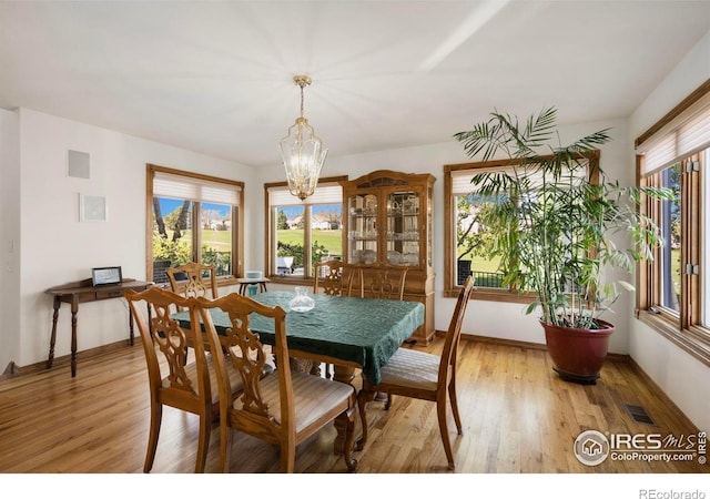 7309 Didrickson Ct, Fort Collins, CO 80528 - dining space featuring a chandelier, light wood finished floors, and baseboards