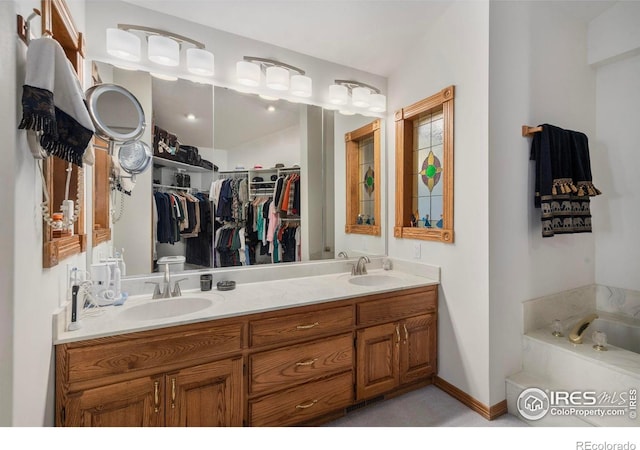 7309 Didrickson Ct, Fort Collins, CO 80528 - full bathroom featuring a spacious closet, double vanity, and a garden tub