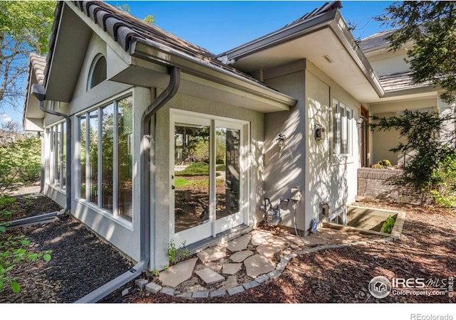 7309 Didrickson Ct, Fort Collins, CO 80528 - view of side of home featuring a sunroom and stucco siding