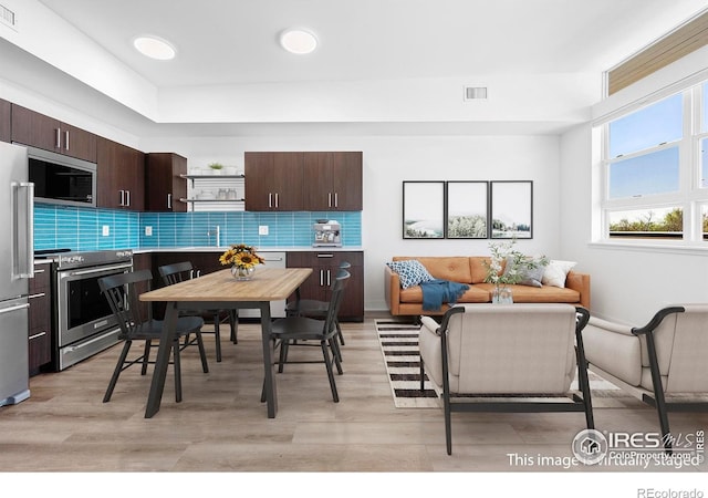dining room with light wood-style flooring