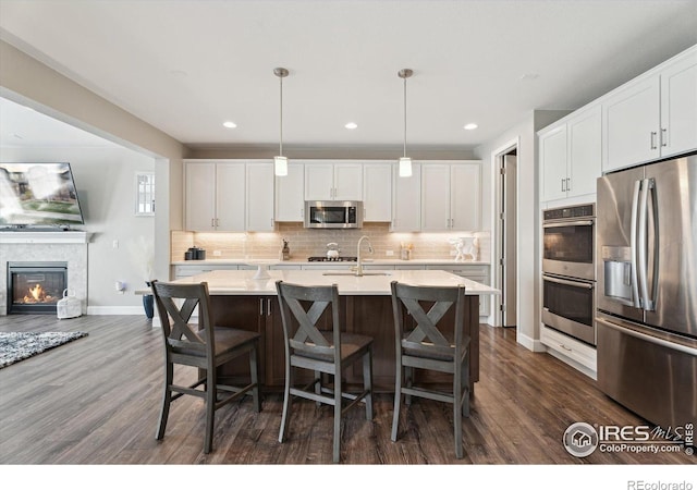 25190 E Nova Pl, Aurora, CO 80016 - kitchen featuring stainless steel appliances, dark wood-type flooring, backsplash, light countertops, and recessed lighting