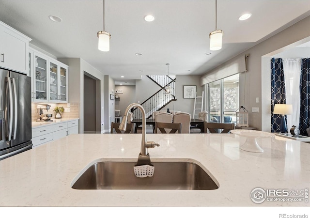 25190 E Nova Pl, Aurora, CO 80016 - kitchen featuring a sink, stainless steel refrigerator with ice dispenser, decorative light fixtures, recessed lighting, and tasteful backsplash