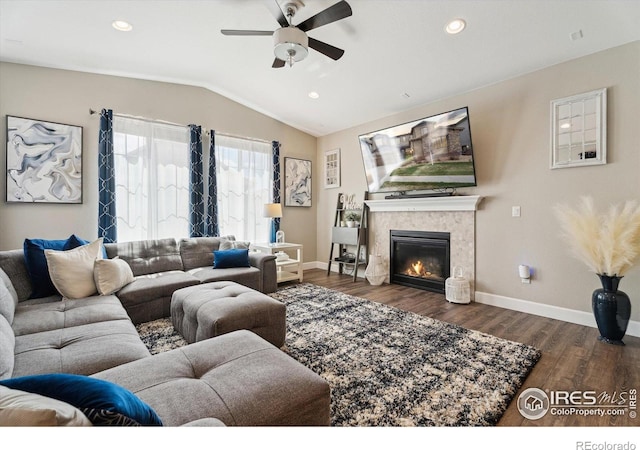 25190 E Nova Pl, Aurora, CO 80016 - living area featuring ceiling fan, lofted ceiling, wood finished floors, a tile fireplace, and baseboards