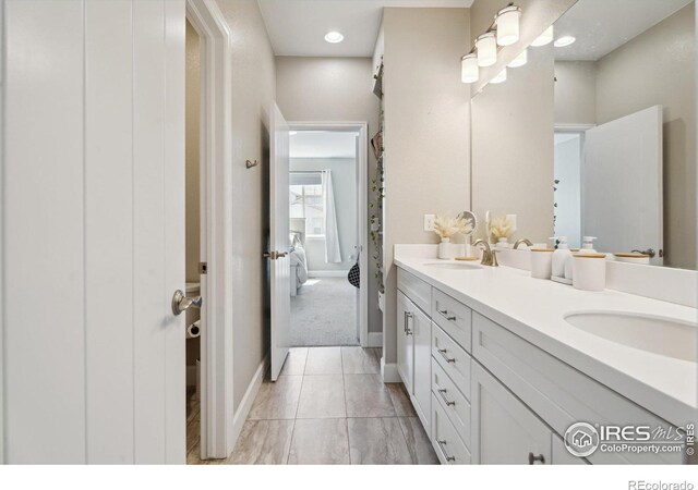 25190 E Nova Pl, Aurora, CO 80016 - full bathroom with double vanity, baseboards, and marble finish flooring