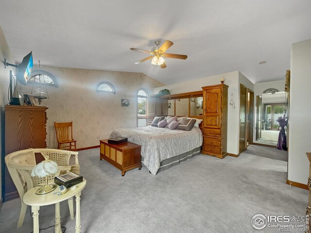 1145 S Bowman Ave, Holyoke, CO 80734 - carpeted bedroom with baseboards, multiple windows, wallpapered walls, ceiling fan, and vaulted ceiling