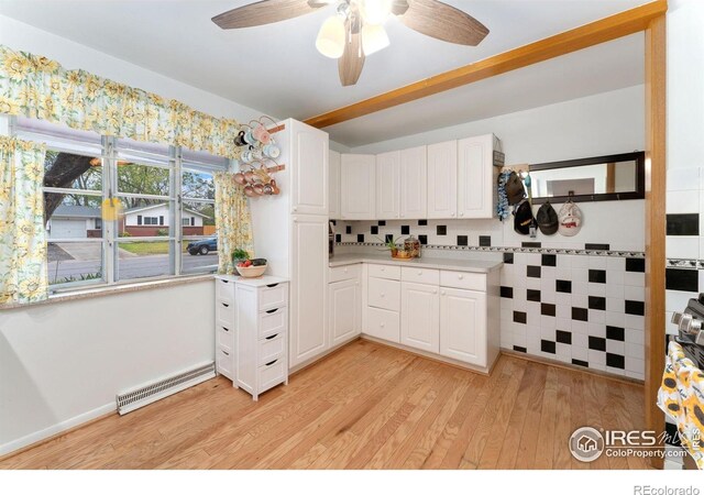 kitchen with white cabinetry, light wood-style floors, ceiling fan, and light countertops