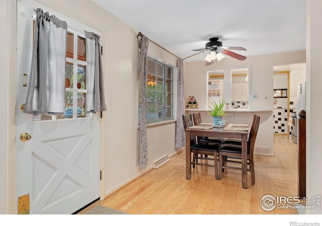 dining room featuring a ceiling fan, wood finished floors, and baseboards