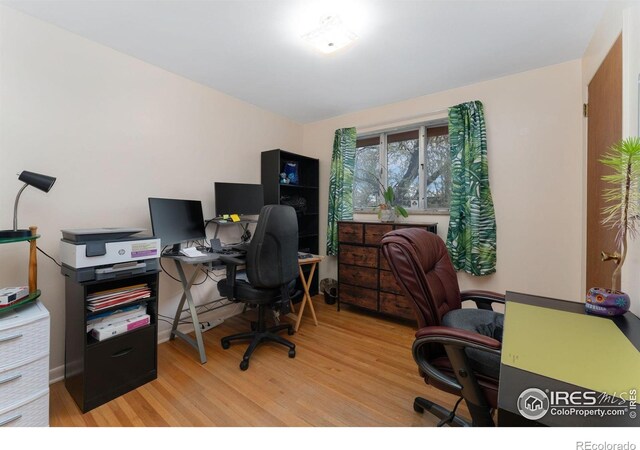 home office with light wood finished floors