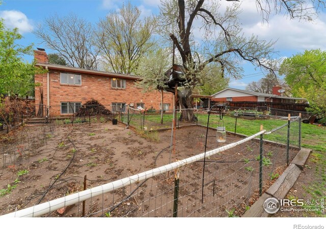 view of yard with a garden and fence