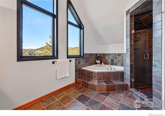 full bath with baseboards, a shower stall, a bath, and lofted ceiling