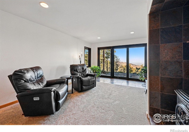 sitting room with carpet floors, recessed lighting, tile patterned floors, and baseboards