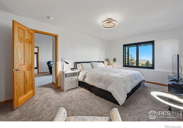 bedroom with carpet and baseboards