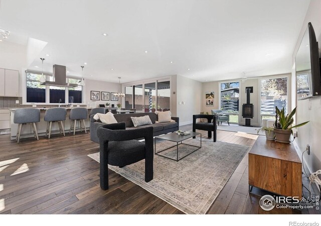 living area featuring dark wood-style floors, recessed lighting, and plenty of natural light