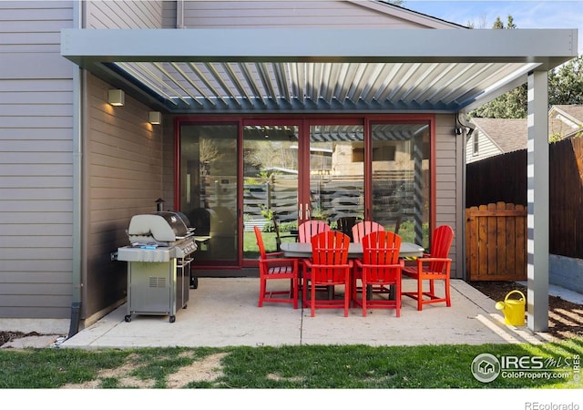 view of patio with area for grilling, fence, outdoor dining space, and a pergola