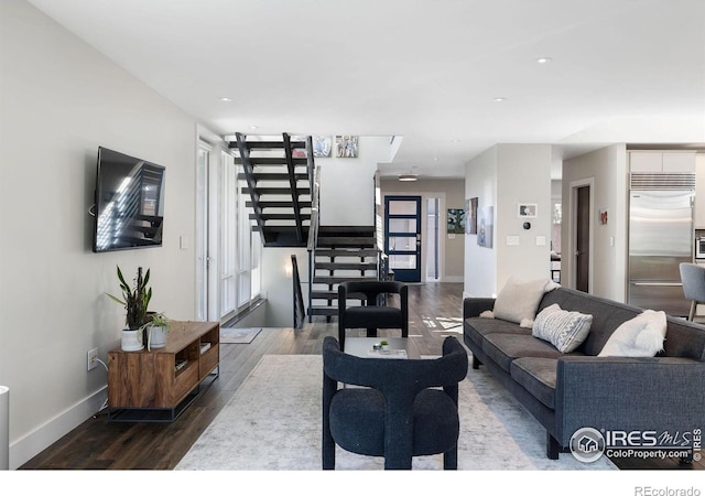 living room with stairway, wood finished floors, baseboards, and recessed lighting