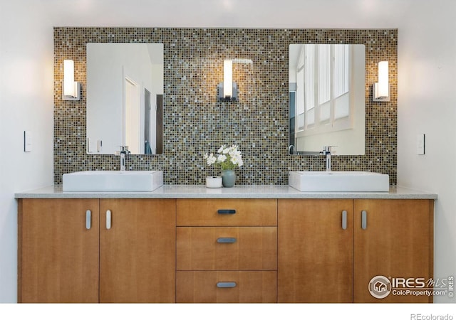 bathroom with decorative backsplash and double vanity