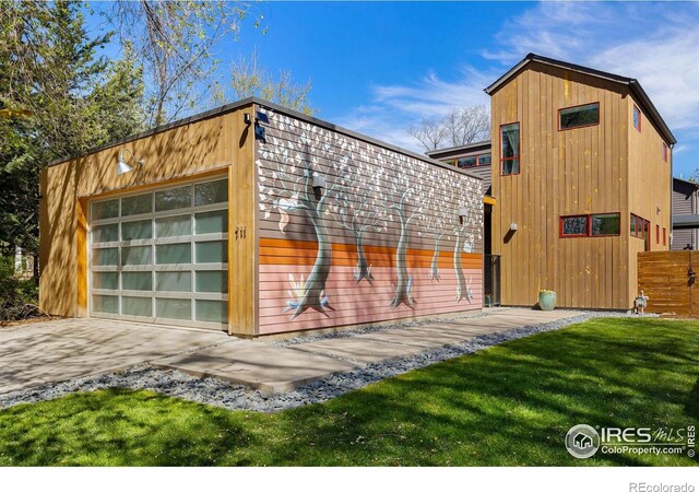 view of outdoor structure featuring an outbuilding, a garage, and concrete driveway