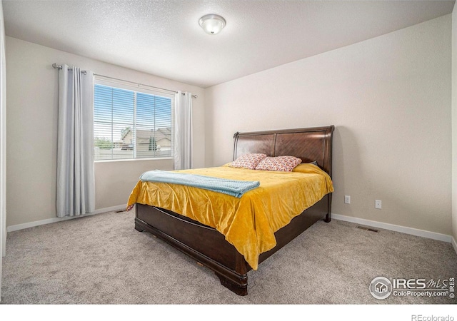 bedroom with carpet and baseboards