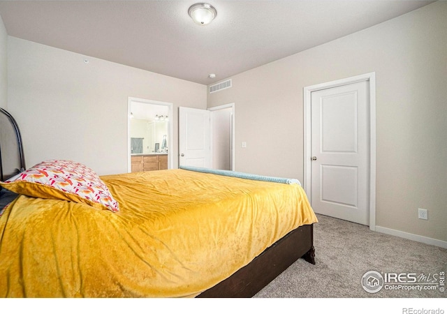 bedroom featuring carpet, connected bathroom, and baseboards
