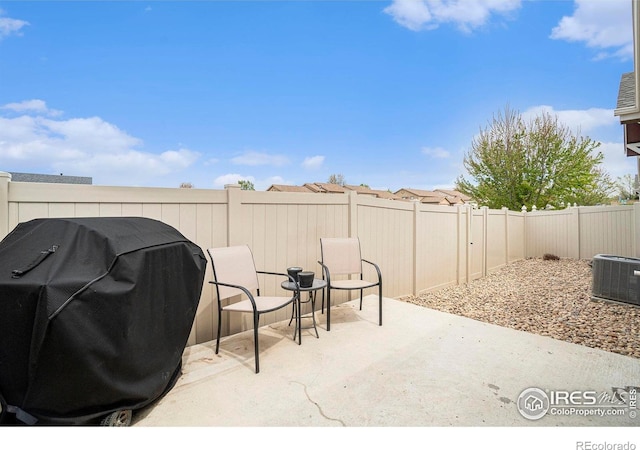 view of patio / terrace featuring a fenced backyard, area for grilling, and cooling unit