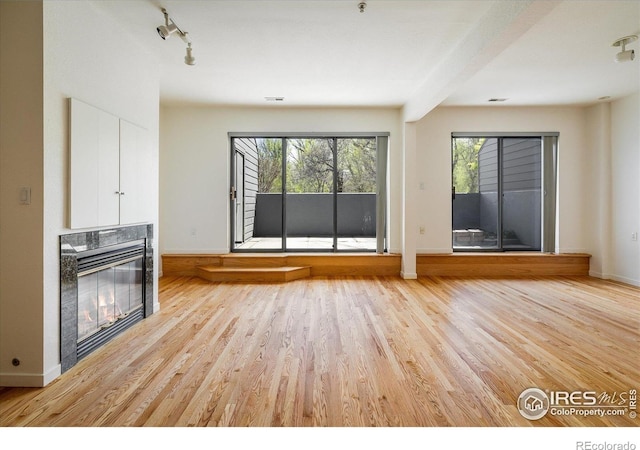 836 Walnut St Unit B, Boulder, CO 80302 - unfurnished living room with a glass covered fireplace, plenty of natural light, light wood finished floors, and baseboards