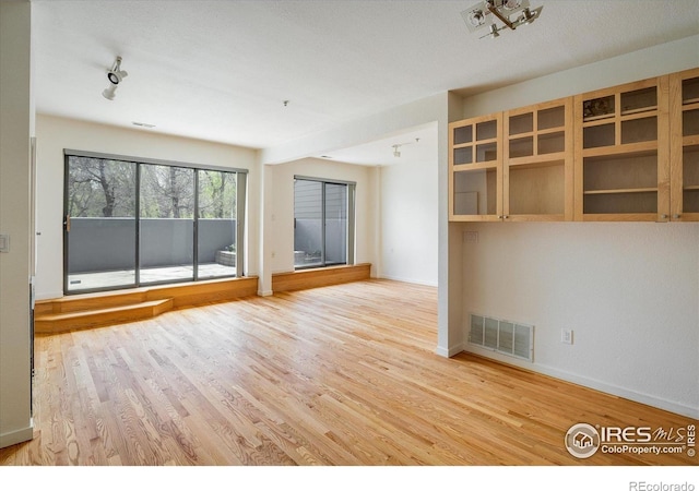 836 Walnut St Unit B, Boulder, CO 80302 - unfurnished living room featuring wood finished floors and baseboards