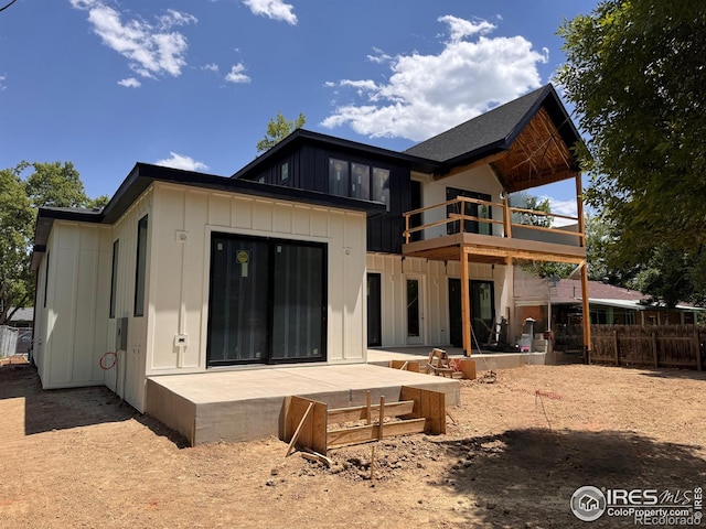 2941 21st St, Boulder, CO 80304 - back of property featuring board and batten siding, a balcony, and a patio area